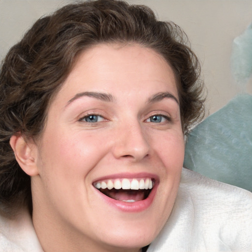 Joyful white young-adult female with medium  brown hair and blue eyes