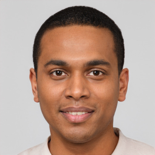 Joyful black young-adult male with short  brown hair and brown eyes