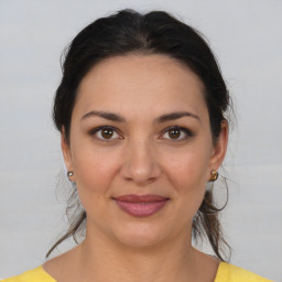 Joyful white young-adult female with medium  brown hair and brown eyes