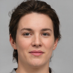 Joyful white young-adult female with medium  brown hair and grey eyes