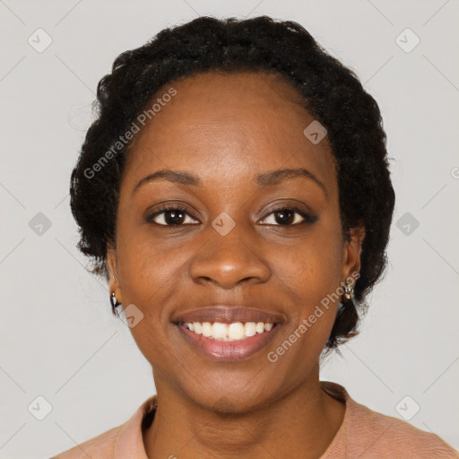 Joyful black young-adult female with short  black hair and brown eyes