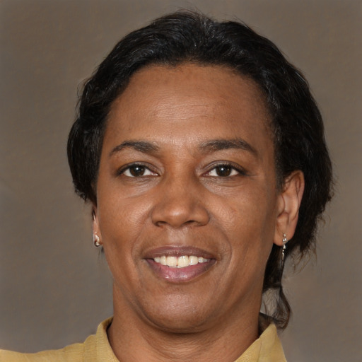Joyful latino adult female with short  brown hair and brown eyes