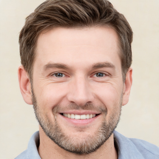 Joyful white young-adult male with short  brown hair and grey eyes