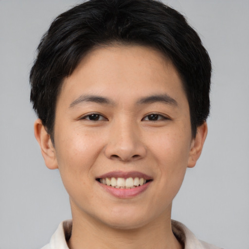 Joyful asian young-adult female with short  brown hair and brown eyes
