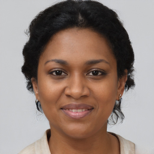 Joyful black adult female with long  brown hair and brown eyes