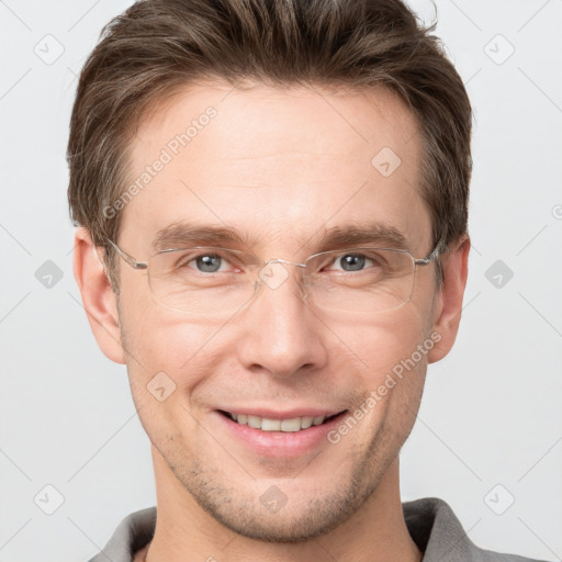 Joyful white adult male with short  brown hair and grey eyes