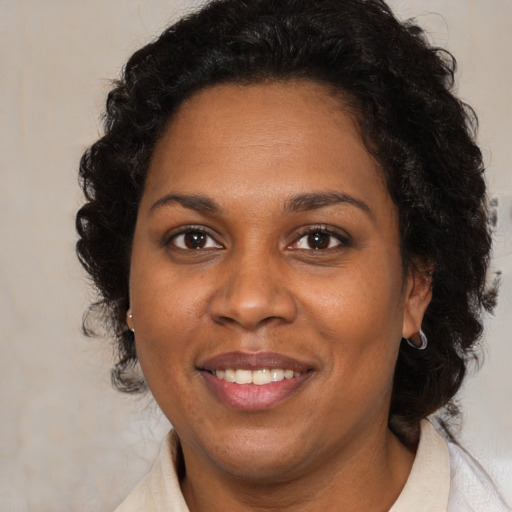 Joyful black young-adult female with medium  brown hair and brown eyes