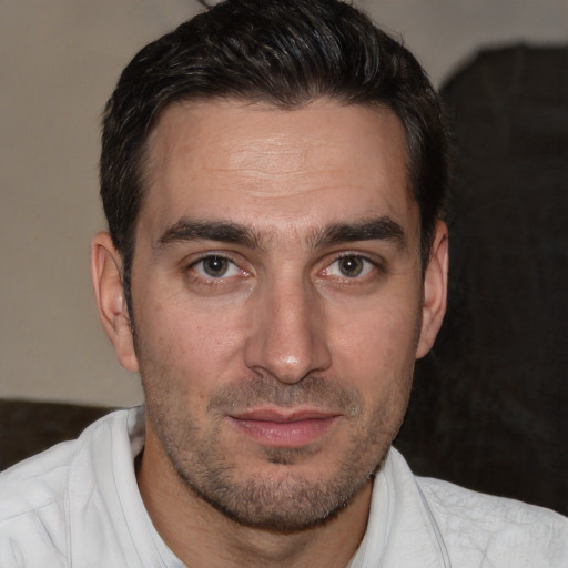 Joyful white adult male with short  brown hair and brown eyes