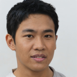 Joyful asian young-adult male with short  black hair and brown eyes