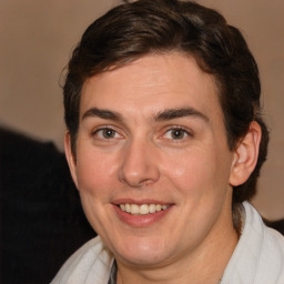 Joyful white young-adult male with medium  brown hair and brown eyes