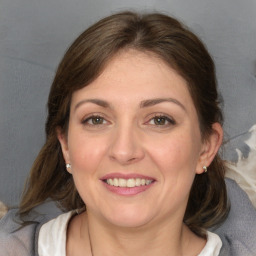 Joyful white adult female with medium  brown hair and grey eyes