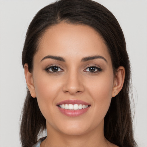 Joyful white young-adult female with long  brown hair and brown eyes