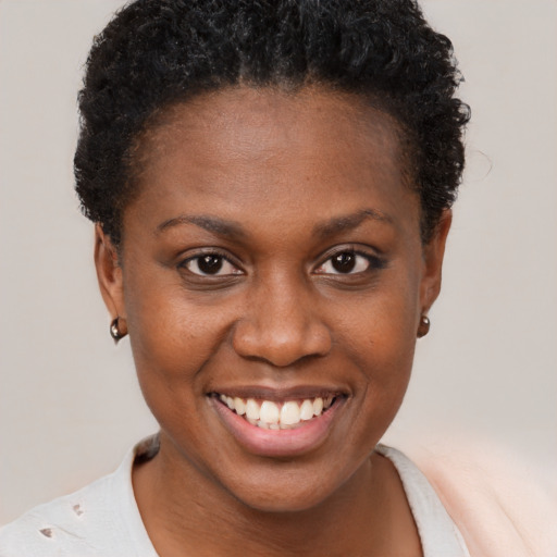 Joyful black young-adult female with short  brown hair and brown eyes