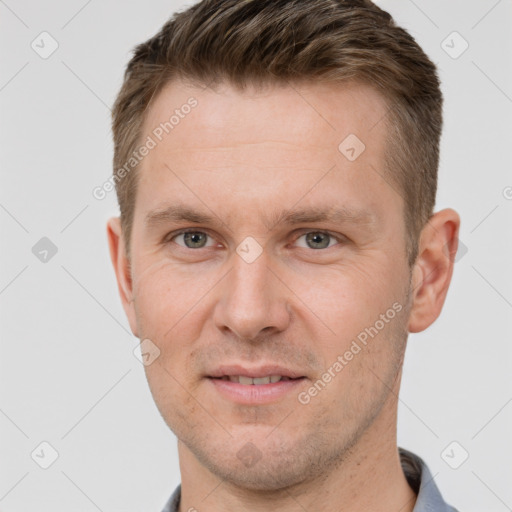 Joyful white adult male with short  brown hair and grey eyes