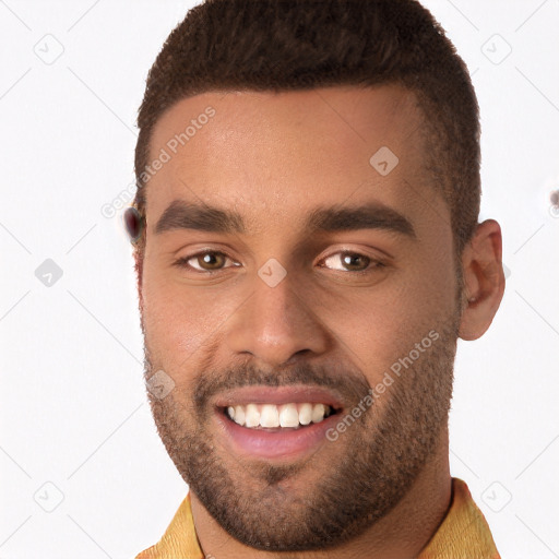 Joyful black young-adult male with short  brown hair and brown eyes