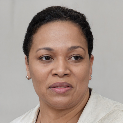 Joyful black adult female with short  brown hair and brown eyes