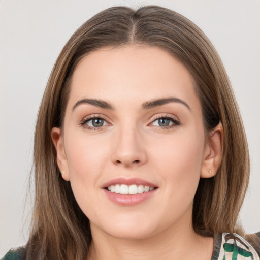 Joyful white young-adult female with long  brown hair and green eyes