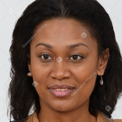 Joyful black adult female with long  brown hair and brown eyes