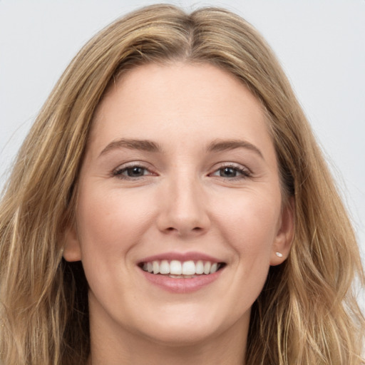 Joyful white young-adult female with long  brown hair and grey eyes