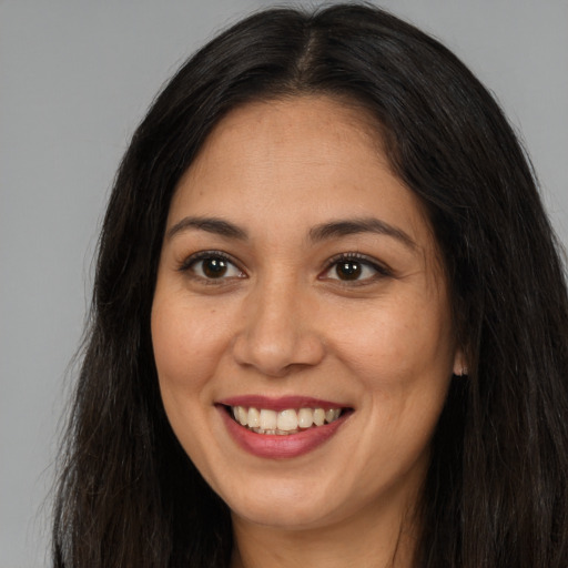 Joyful asian young-adult female with long  brown hair and brown eyes