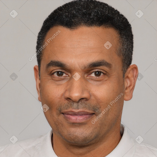 Joyful latino adult male with short  black hair and brown eyes