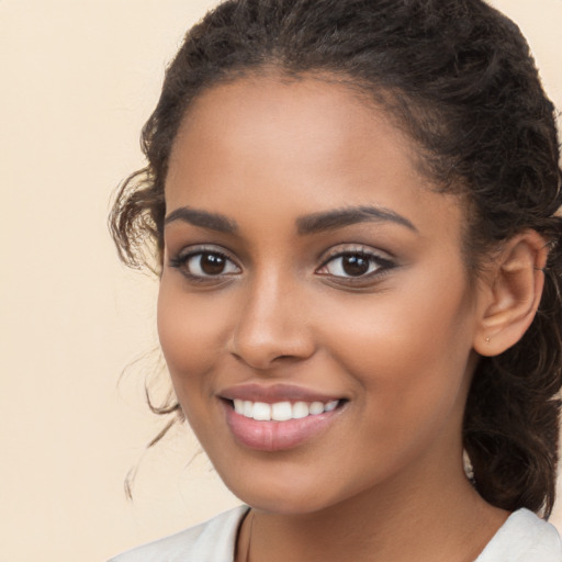 Joyful latino young-adult female with long  brown hair and brown eyes