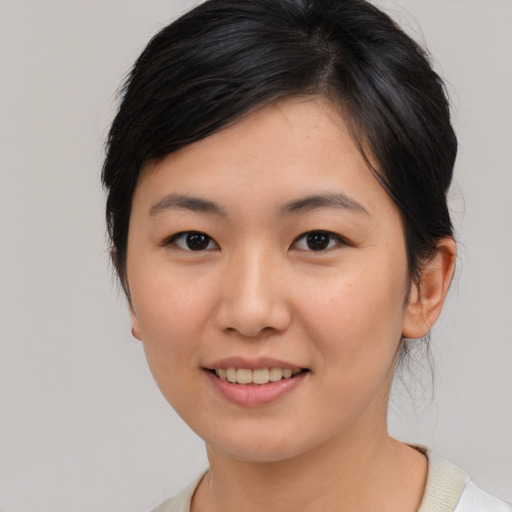 Joyful asian young-adult female with medium  brown hair and brown eyes