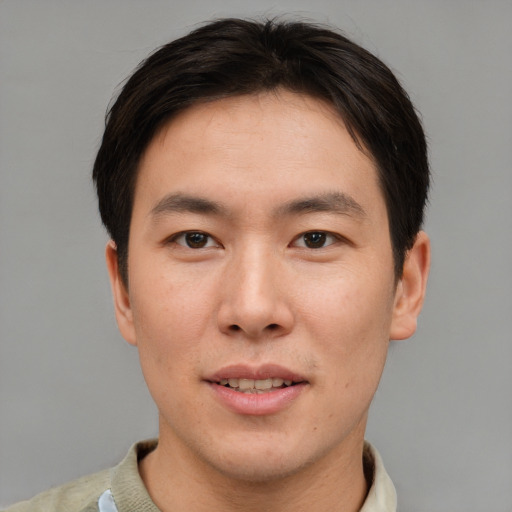 Joyful asian young-adult male with short  brown hair and brown eyes