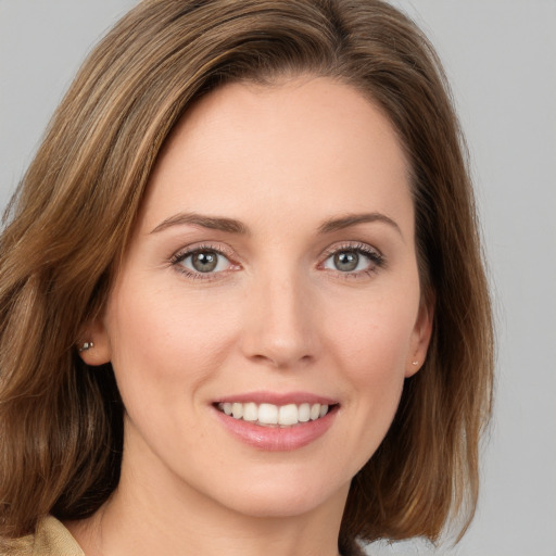 Joyful white young-adult female with medium  brown hair and brown eyes