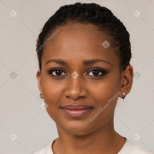 Joyful black young-adult female with short  brown hair and brown eyes