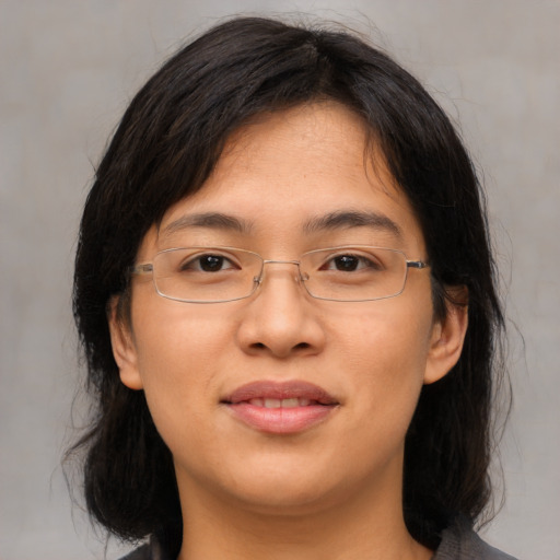 Joyful asian adult female with medium  brown hair and brown eyes