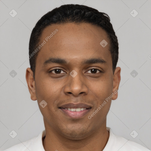 Joyful black young-adult male with short  black hair and brown eyes