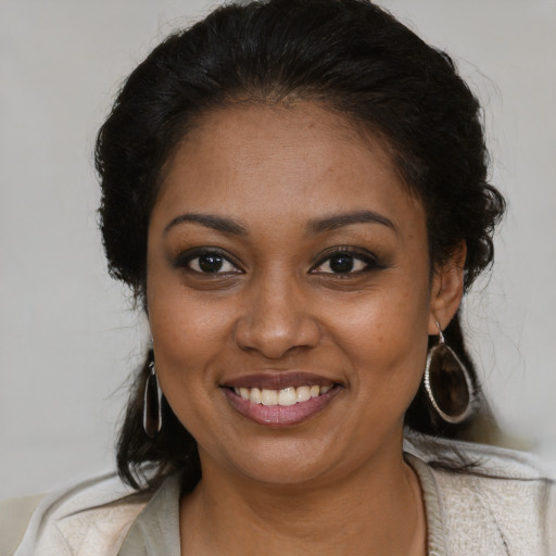 Joyful black young-adult female with medium  brown hair and brown eyes