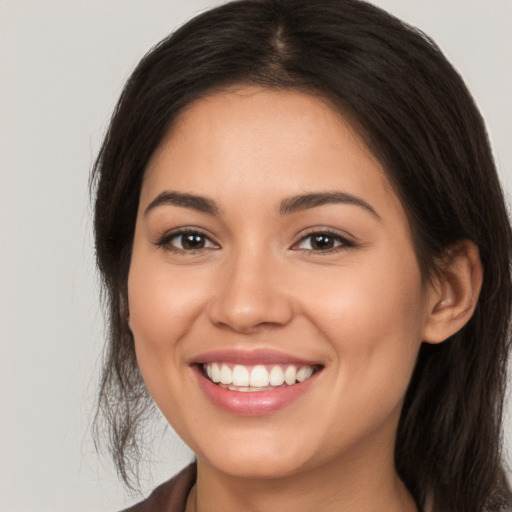 Joyful white young-adult female with long  brown hair and brown eyes