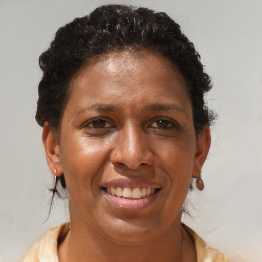 Joyful black adult female with short  brown hair and brown eyes