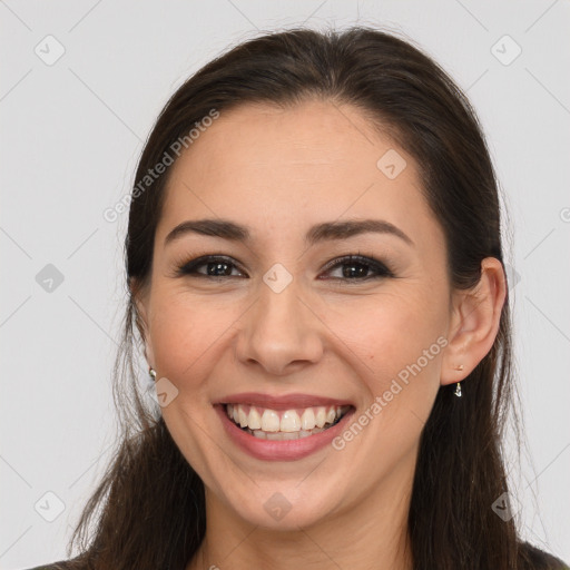 Joyful white young-adult female with long  brown hair and brown eyes