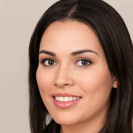 Joyful white young-adult female with long  black hair and brown eyes