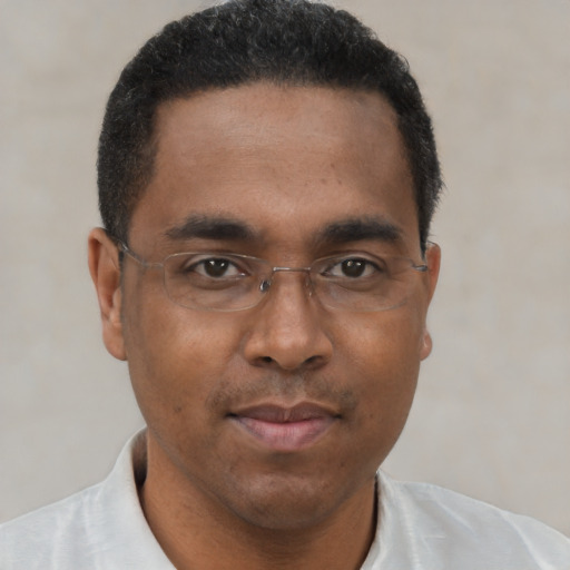 Joyful black young-adult male with short  brown hair and brown eyes