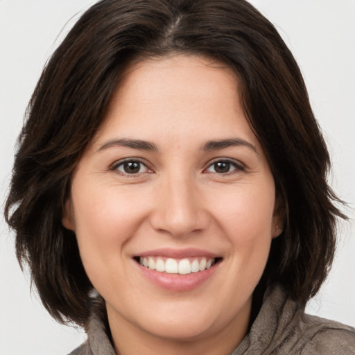 Joyful white young-adult female with medium  brown hair and brown eyes