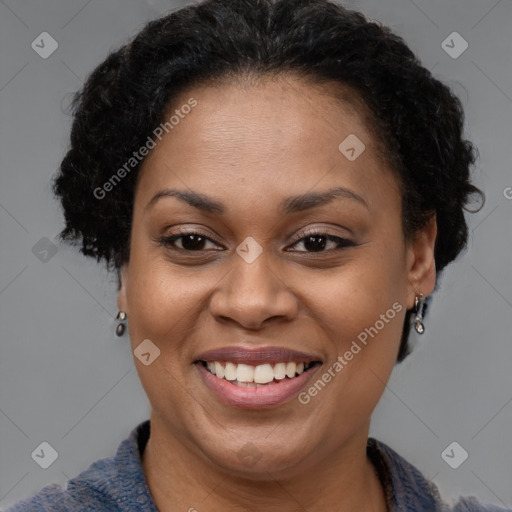 Joyful black adult female with short  brown hair and brown eyes