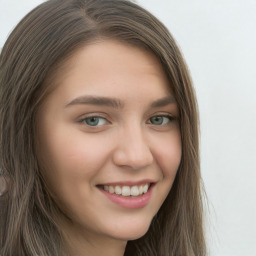 Joyful white young-adult female with long  brown hair and green eyes