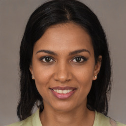 Joyful black young-adult female with medium  brown hair and brown eyes