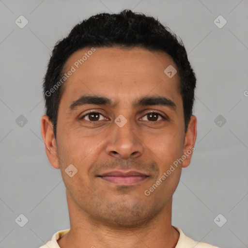 Joyful latino young-adult male with short  black hair and brown eyes