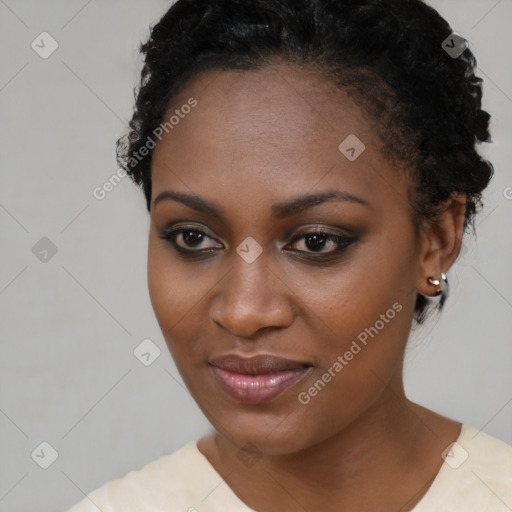 Joyful black young-adult female with short  brown hair and brown eyes