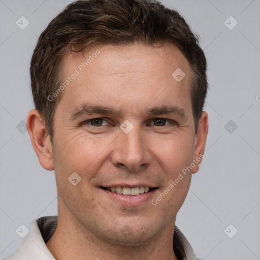 Joyful white adult male with short  brown hair and grey eyes