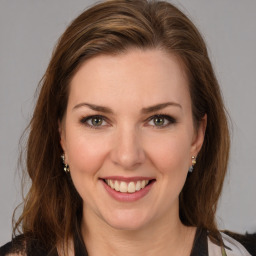 Joyful white young-adult female with long  brown hair and green eyes