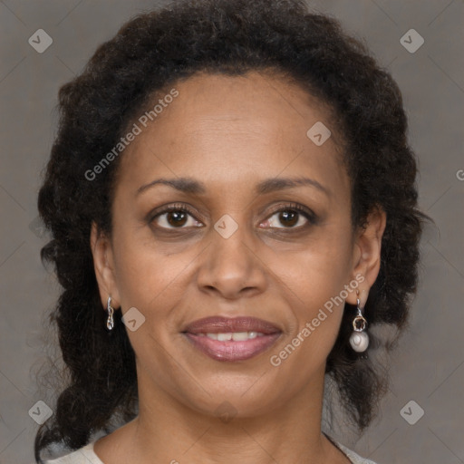 Joyful black adult female with medium  brown hair and brown eyes