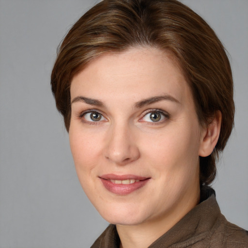 Joyful white young-adult female with medium  brown hair and grey eyes