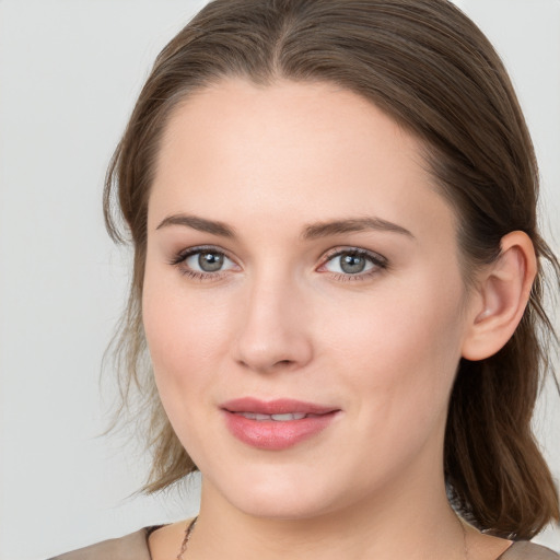 Joyful white young-adult female with long  brown hair and grey eyes