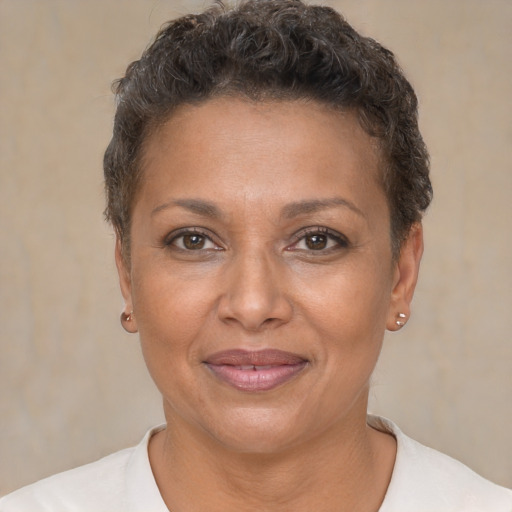 Joyful black adult female with short  brown hair and brown eyes